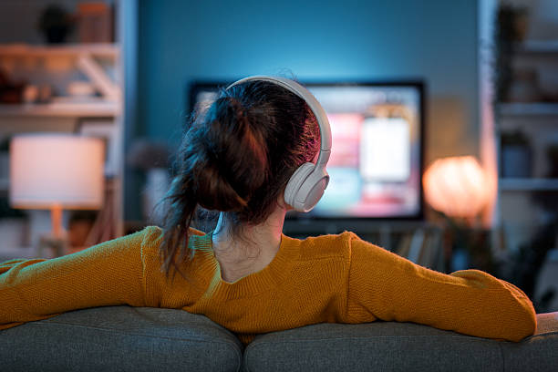 istock woman watching TV at home 2239484843