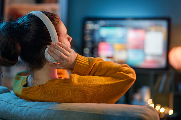 istock woman watching TV at home 2239484845