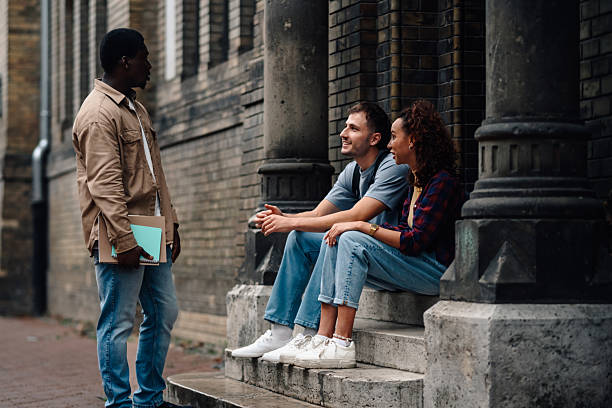istock University students chatting on stairs of campus building 2239485519