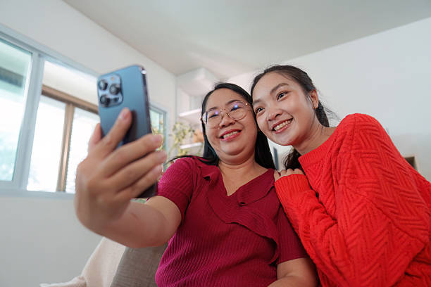 istock Mother and daughter taking a joyful selfie together 2239486391