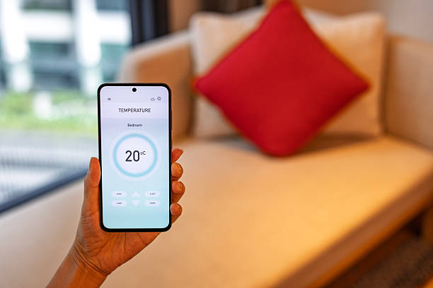 istock Adjusting living room temperature with smart home mobile application 2239488418