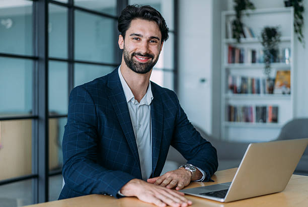 istock Successful businessman in modern office working on laptop. 2239489289
