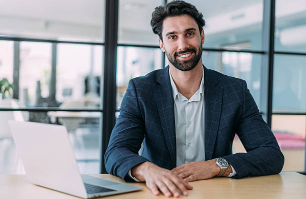istock Successful businessman in modern office working on laptop. 2239489305
