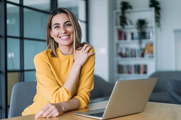 istock Successful businesswoman in modern office working on laptop. 2239489844