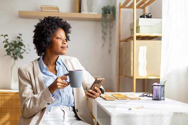 istock Woman taking coffee break in home office looking thoughtful 2239490124