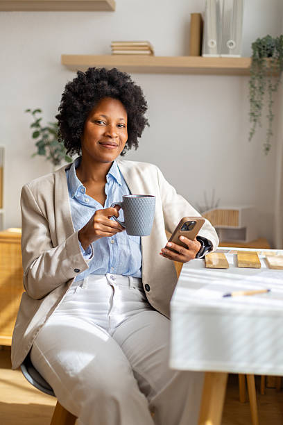 istock Black woman smiling while working from home office 2239490131