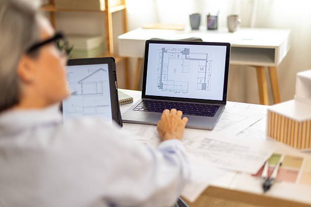 istock Architect woman planning house design using laptop digital tablet 2239490195