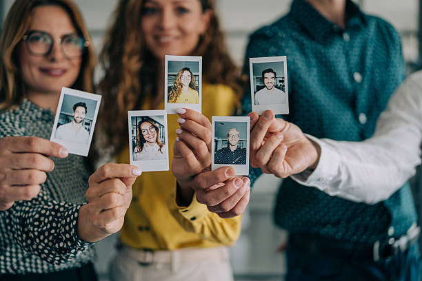 istock Happy colleagues making photos with instant camera. 2239490531