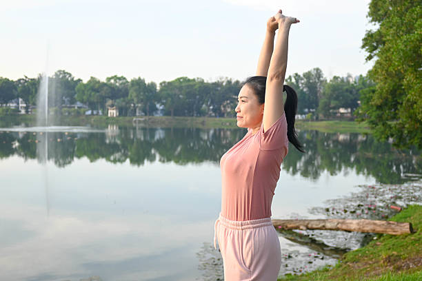 Energetic young woman stretches before her morning run, embracing fitness and an active lifestyle.