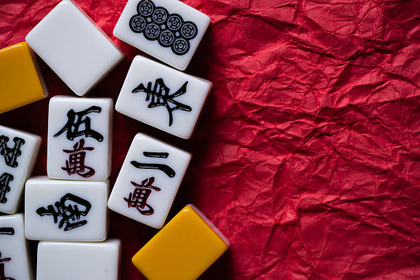 istock Mahjong tiles lined up on a red background 2239494602