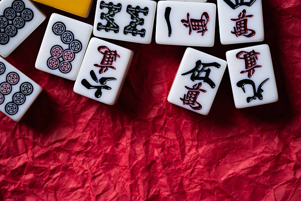 istock Mahjong tiles lined up on a red background 2239494650