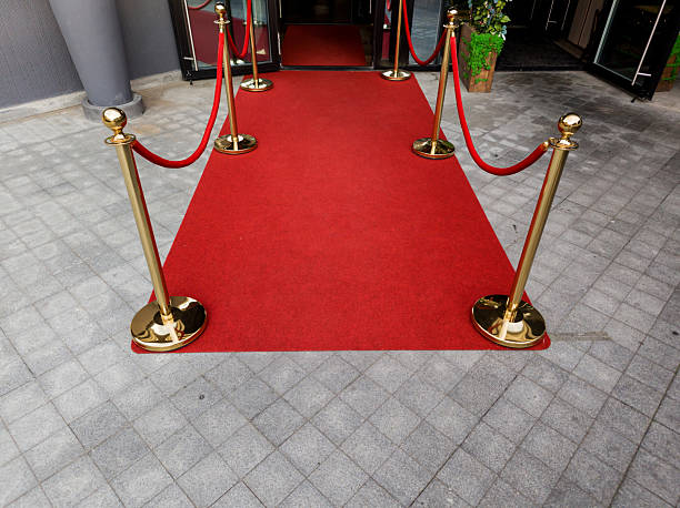 istock Red carpet with golden stanchions and ropes 2239495127