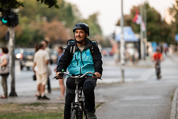 istock Delivery man riding bicycle in urban street during working hours 2239497306
