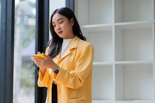 istock Asian businesswoman using mobile phone in office 2239499329