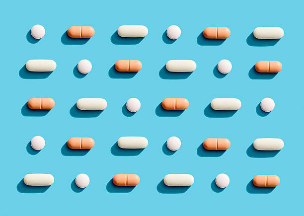 istock Pattern of medicine pills and capsules on blue background 2239499882