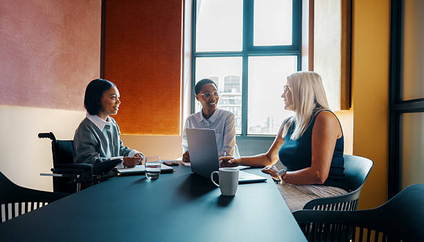 istock Three diverse women discussing ideas in an office meeting space 2239502199
