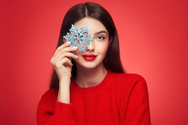 istock Beautiful young woman with glowing snowflake 2239502856