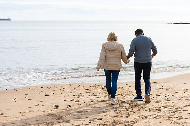 istock Senior Couple Holding Hands on a Peaceful Beach Walk 2239505456