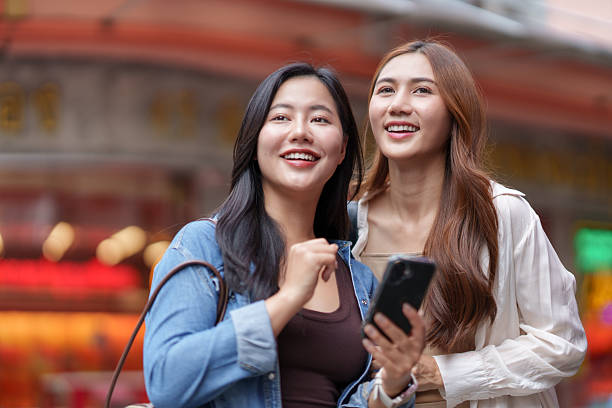 istock Asian friends exploring city street using smartphone 2239506758