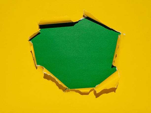 istock Abstract Ripped Yellow Paper with Green Background Blank Space 2239510226