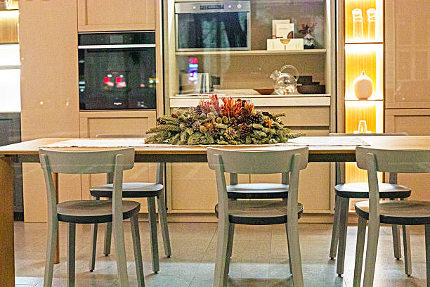 Stylish kitchen interior with flowers and a Christmas tree on the table