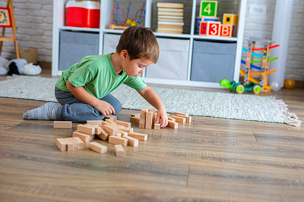 istock Creative Child Constructing with Wooden Toys in Playroom 2239511478