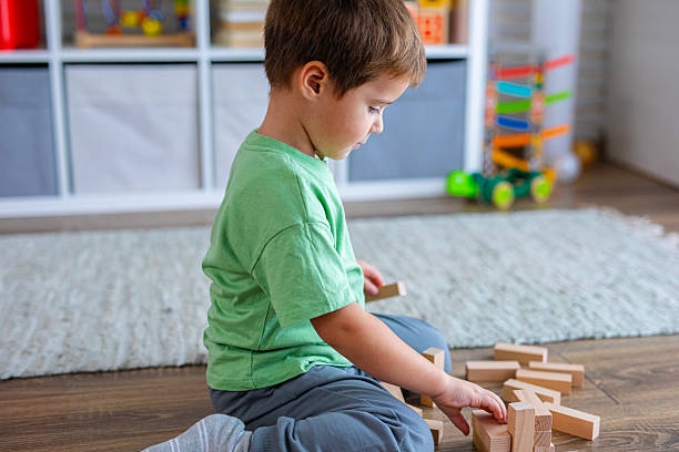 istock Creative Child Constructing with Wooden Toys in Playroom 2239511524