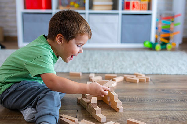 istock Creative Child Constructing with Wooden Toys in Playroom 2239511569