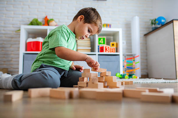 Creative Child Constructing with Wooden Toys in Playroom