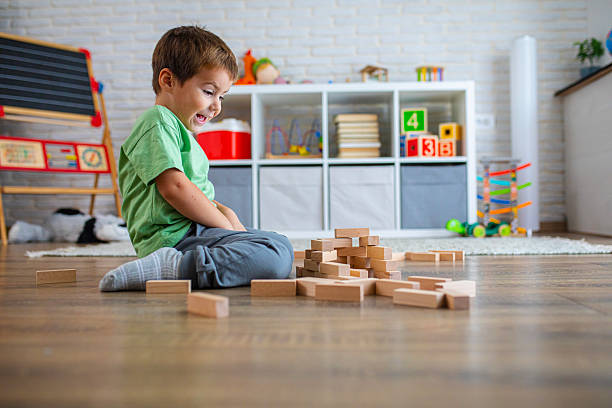 istock Creative Child Constructing with Wooden Toys in Playroom 2239512232