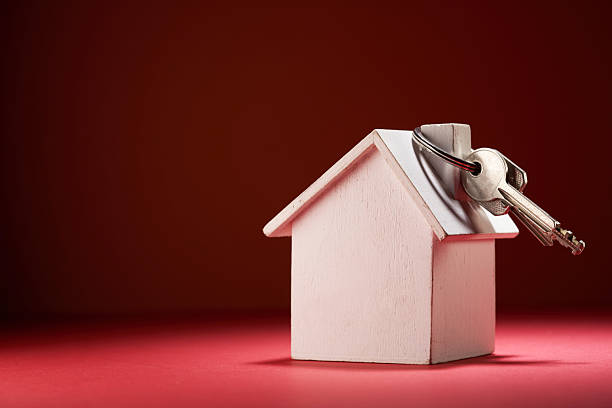 istock model house and house key against red background 2239512313
