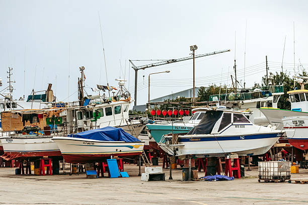 Metal yacht, old boat ashore in a harbor boatyard for the winter storage and repair works before landing