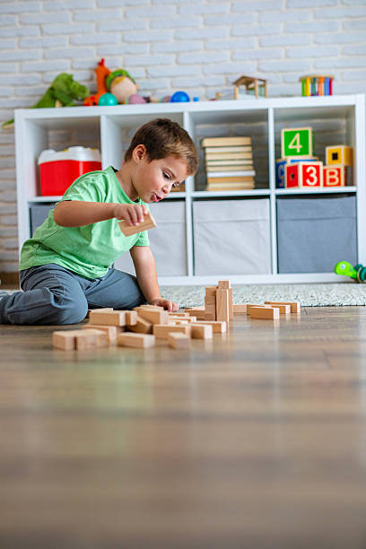 istock Creative Child Constructing with Wooden Toys in Playroom 2239513332