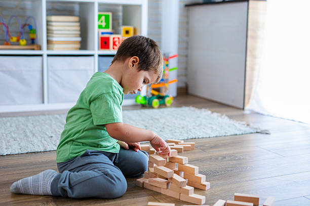 istock Creative Child Constructing with Wooden Toys in Playroom 2239513424