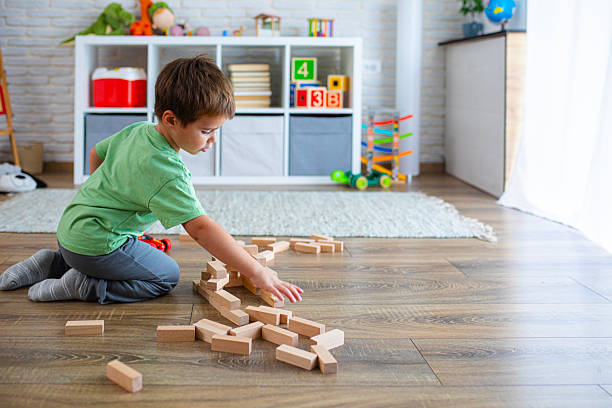 istock Creative Child Constructing with Wooden Toys in Playroom 2239513904