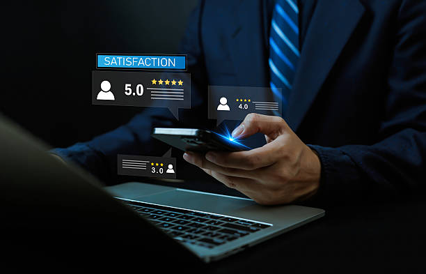 istock Businessman using smartphone and laptop with customer satisfaction, feedback, and star rating icons, symbolizing online review management, digital marketing, and brand reputation analytics. 2239514408