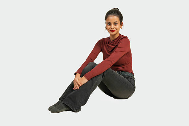 istock Young woman sitting on white background smiling 2239514439