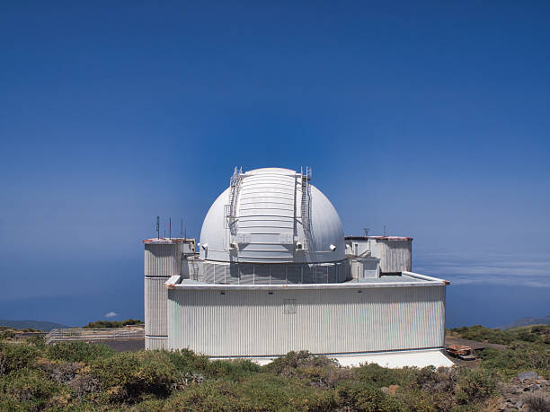 istock Telescope dome at Roque de los Muchachos Observatory - A white observatory telescope dome standing high above the sea of clouds (mar de nubes) on the summit of Roque de los Muchachos, La Palma. 2239515656