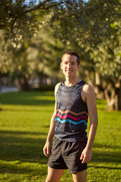 istock Young man smiling, enjoying outdoor workout in park 2239519026