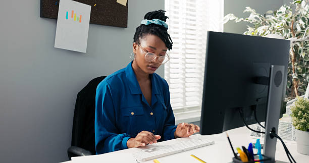 istock A dedicated company secretary sits in front of her computer, writing emails, processing documents, and preparing detailed reports and meeting notes for the manager. 2239519986
