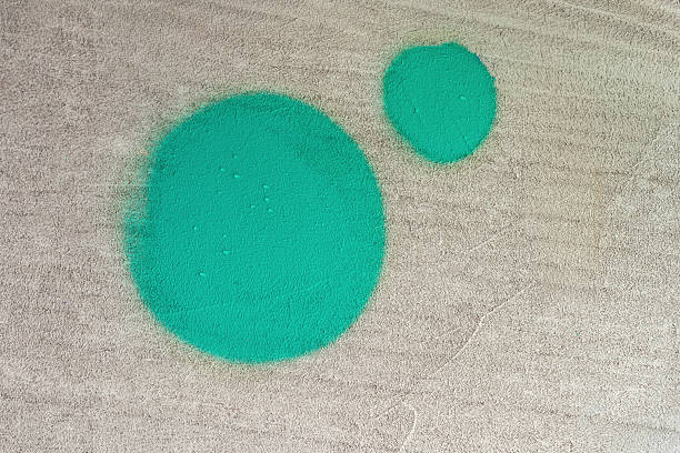 Two green painted circles on beige rough wall surface. Graphic grunge texture. Abstract modern background. Urban texture, street abstract art, color contrast, minimal contemporary wall design