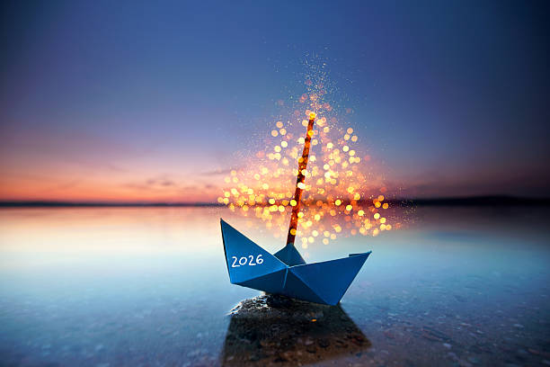 Sailing into 2026: A Luminous Paper Boat on a Sunset Sea