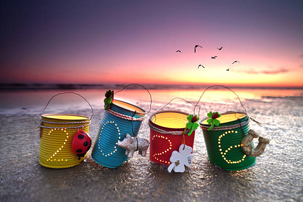 self crafted Radiant Tin Can Lanterns Welcoming 2026 at a Sunset Beach