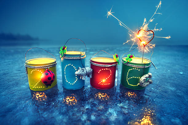 istock Glowing Tin Can Lanterns with Sparkling 2026 Illuminations on a Frozen Sea 2239525878