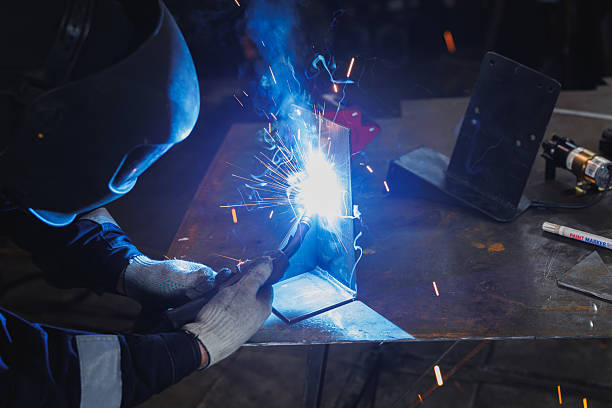 istock A man is carefully welding a piece of metal on a work table 2239527853