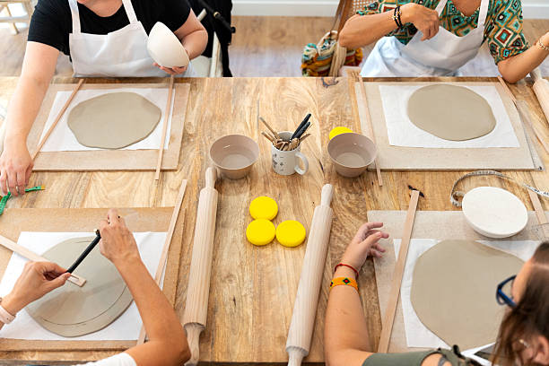istock Women learning pottery craft in ceramics workshop 2239530063