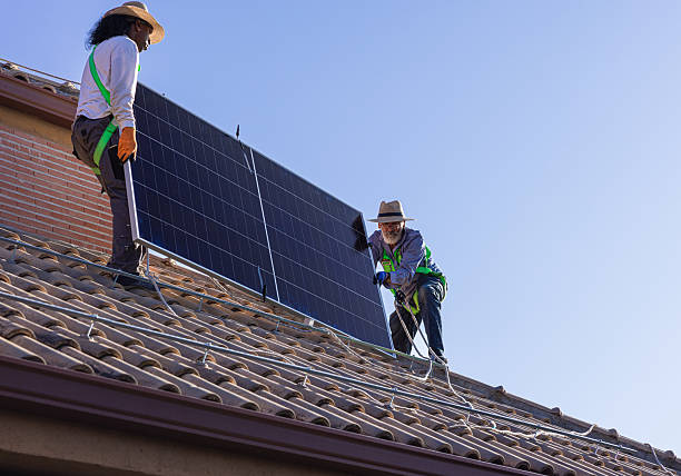 istock Technicians installing solar panels on a house roof, promoting renewable energy 2239530440
