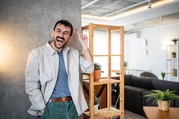 istock Man having great idea pointing up in modern home 2239531923