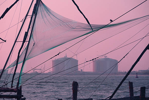 Kochi Chinese fishnets on sunset in Fort Kochin, Kochi, Kerala, India