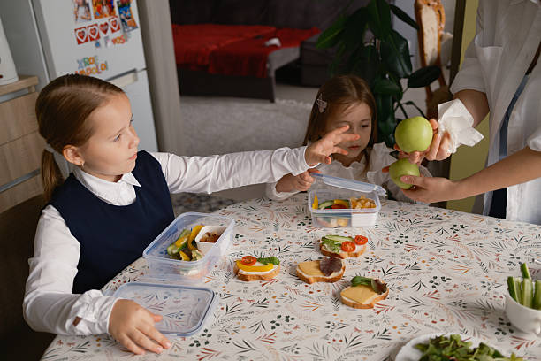 istock Children preparing healthy school lunches with fresh apples 2239532859